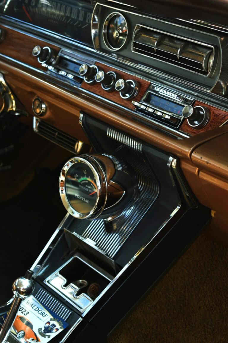Interior view of a vintage car dashboard featuring retro audio equipment and classic design elements.